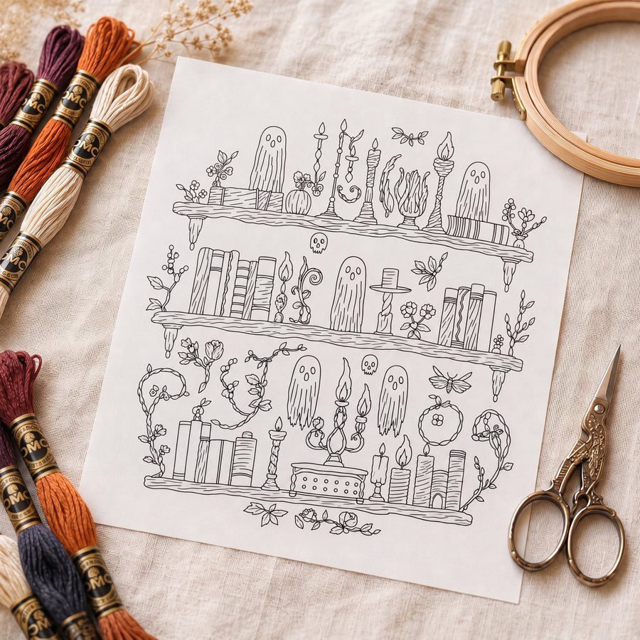 A printed stick and stitch embroidery design sheet with cotton threads, an empty wooden hoop and embroidery scissors on linen
