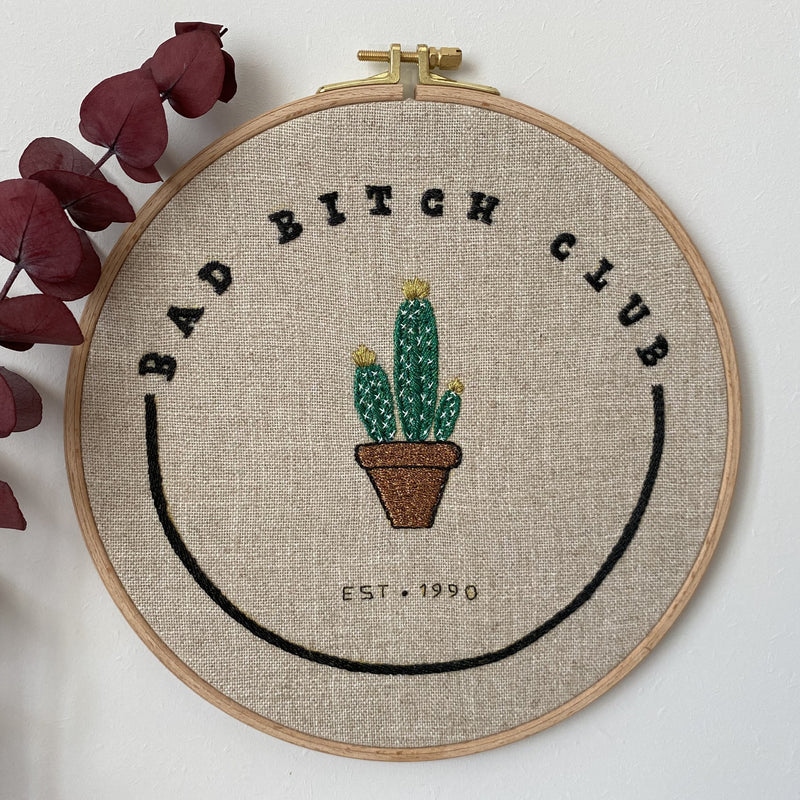 Bad Bitch Club cactus hand embroidery in a wooden hoop on natural linen, with dried eucalyptus