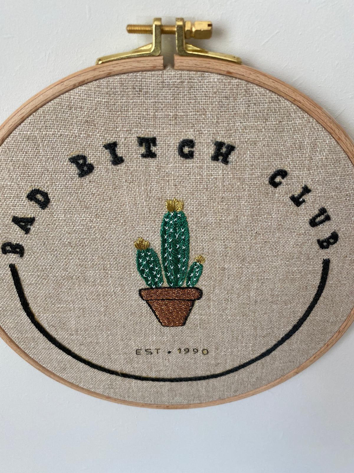 The Bad Bitch Club cactus hoop laid flat on a white surface