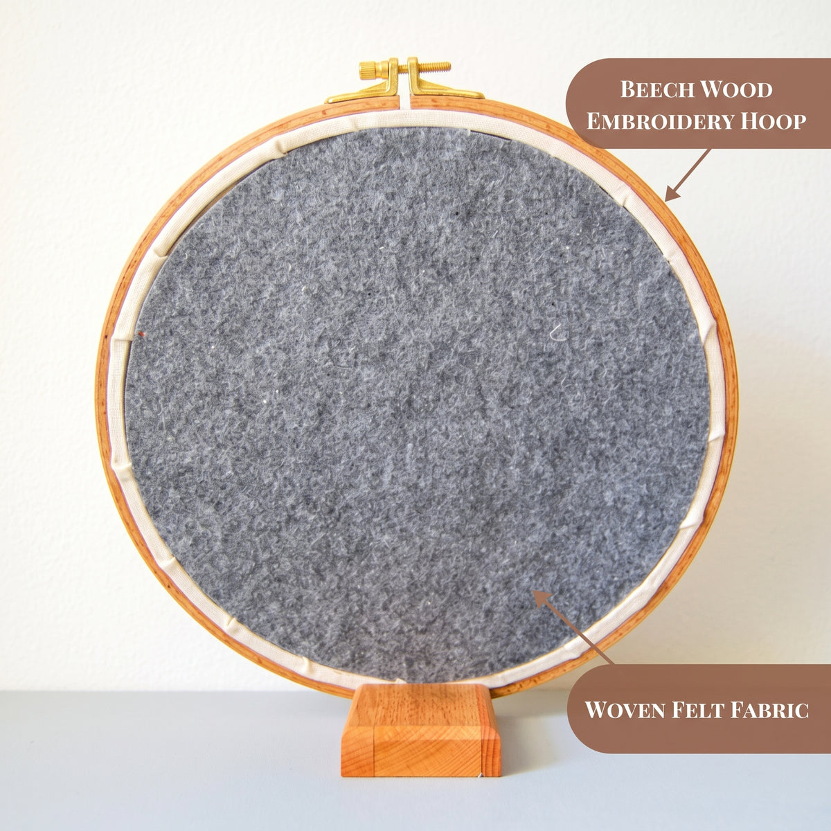 The back of a finished hand embroidery hoop, showing the beech wood hoop and woven felt backing