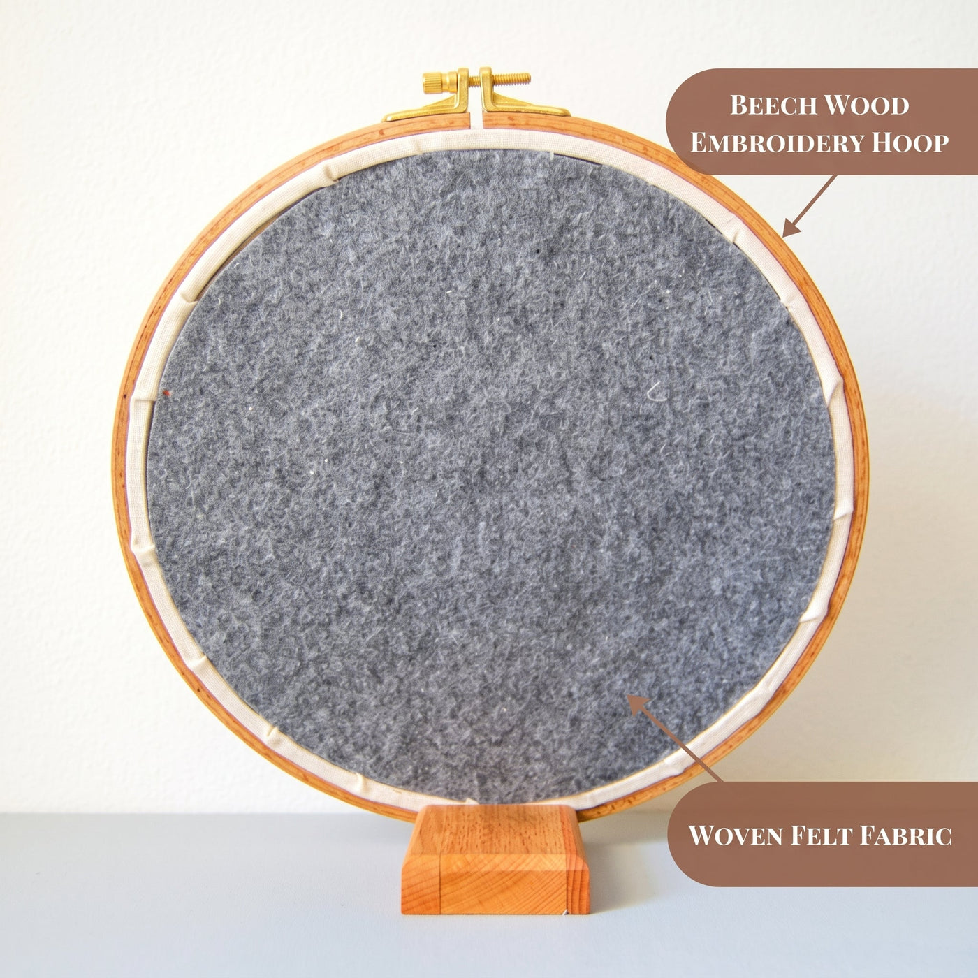 The back of a finished hand embroidery hoop, showing the beech wood hoop and woven felt backing