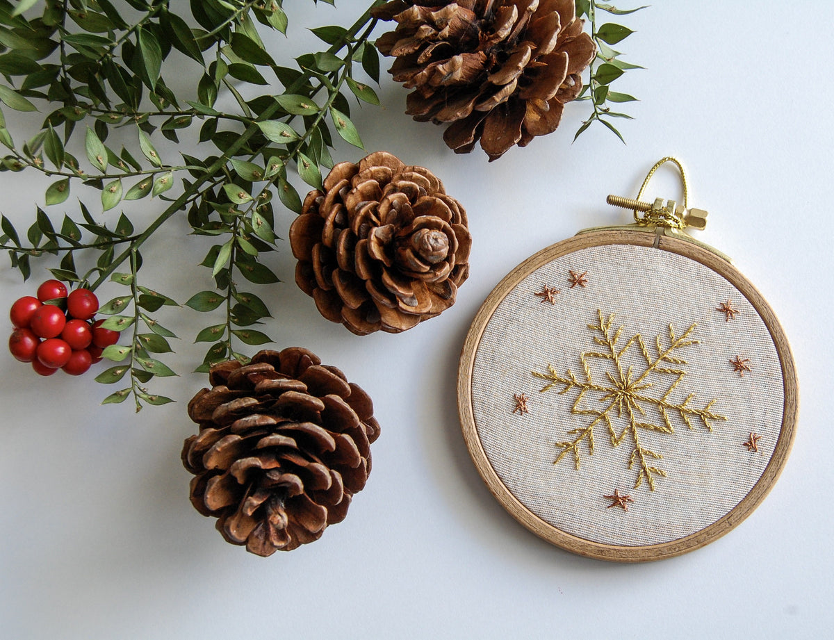 The golden snowflake hoop with pine cones, red berries and foliage