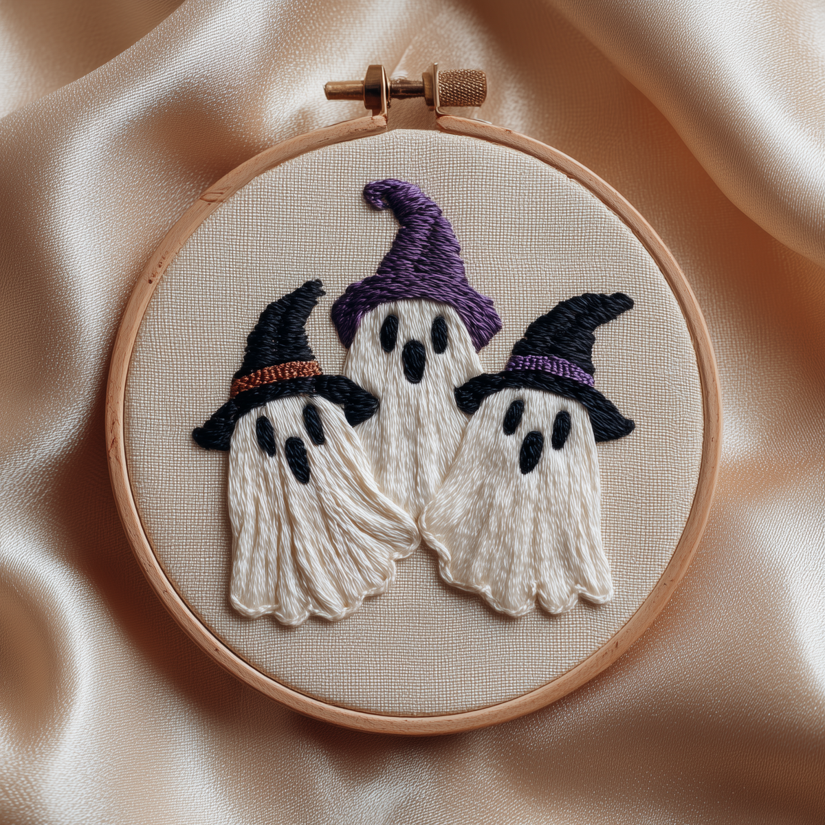 Three ghosts in purple and black witch hats, finished hand embroidery hoop photographed in full