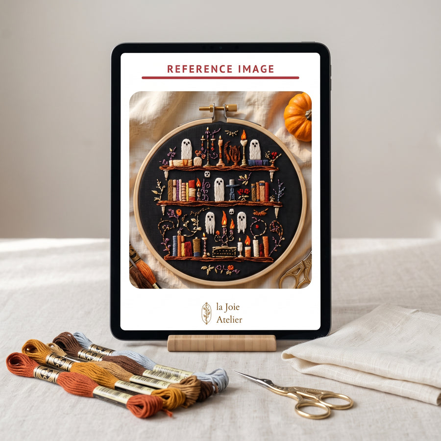 The month's Mail Club Edition shown as a reference image on a tablet beside embroidery threads and scissors