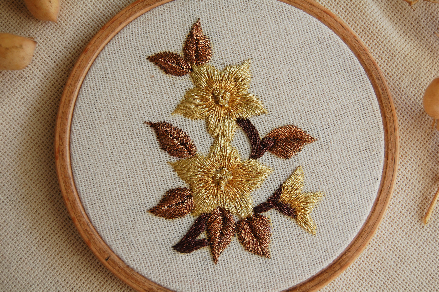 Close view of the amber mini golden blooms design, showing the raised metallic petals